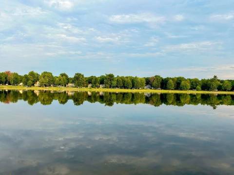 Lakeside Sunsets at this 3-bedroom lake cottage that sleeps 12 on Secord Lake.