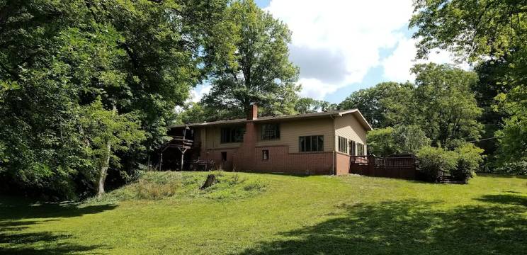Nestled near woods and creek, this large home is near state parks and colleges..