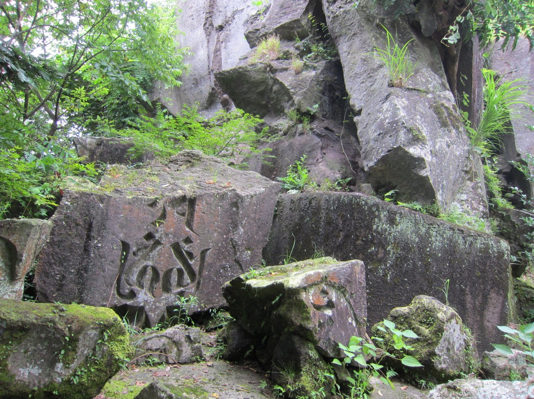 Curved Sanskrit Characters Group on the Polished Cliff in Aoki