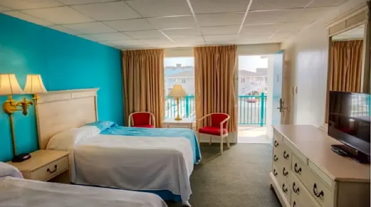Comfortable hotel room with two beds and TV at Dunes Court
