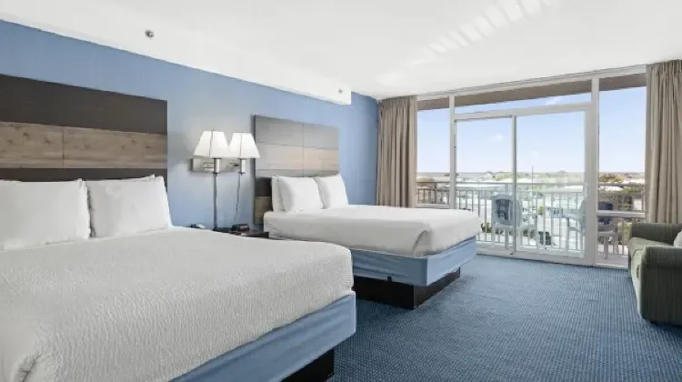 Spacious hotel room with balcony and distant view at Carousel Resort Hotel and Condominiums