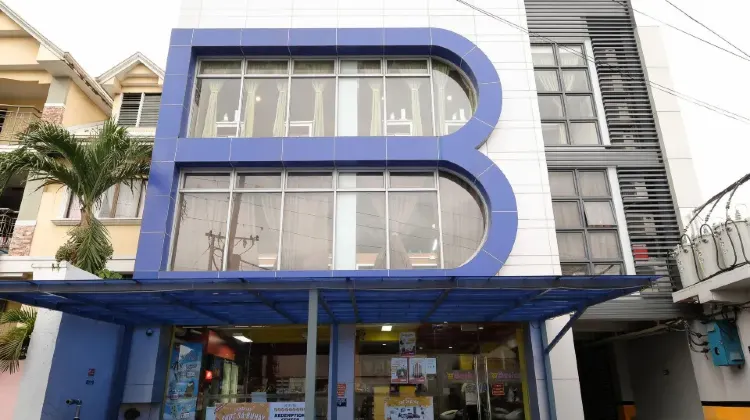 Building exterior designed with the hotel's initials at Bed and Bath Serviced Suites