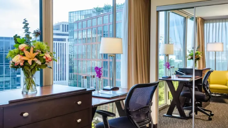 Beacon Hotel & Corporate Quarters-The hotel room is equipped with tables, chairs and bright floor-to-ceiling windows.
