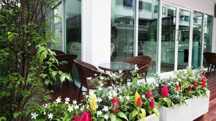 Hotel terrace area surrounded by flowers at Nantra Ekamai Hotel