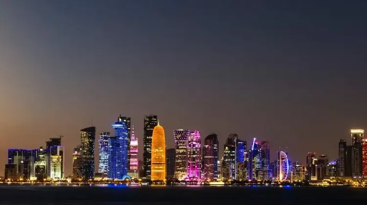 Source: Flavius Torcea/ unsplash  Doha skyline at night.