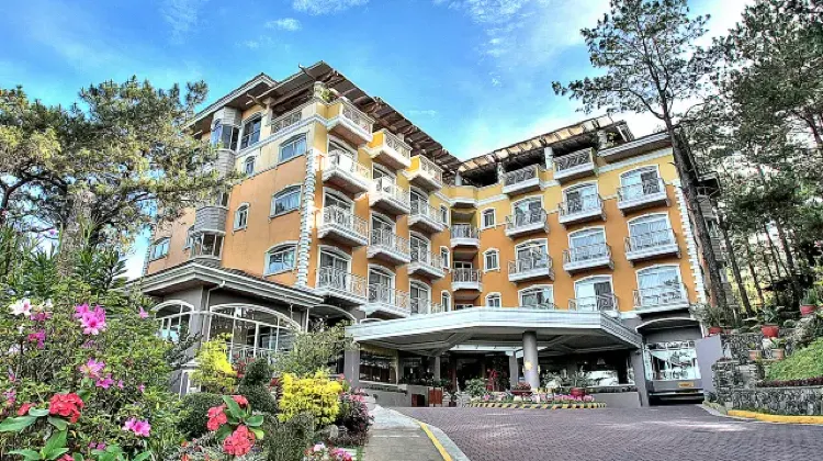 The exterior of the hotel building surrounded by greenery at Hotel Elizabeth - Baguio