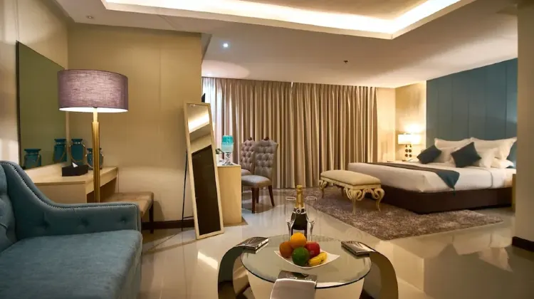 Elegant hotel room with sofa and bed and coffee table at J7 Hotel Iloilo