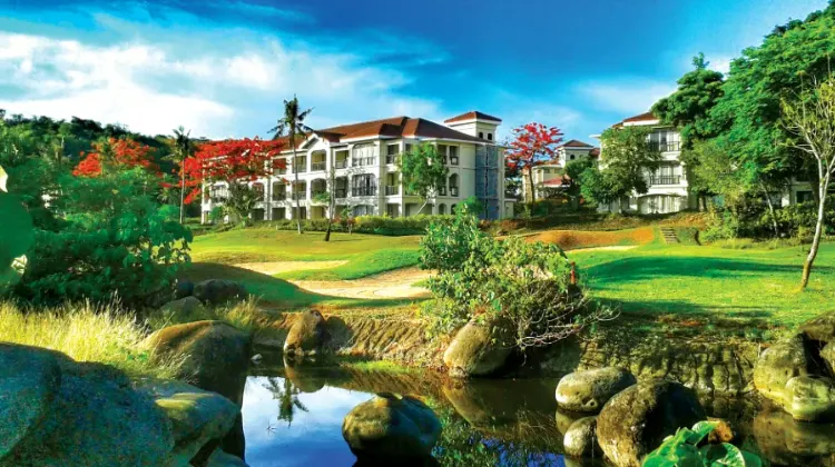 Hotel building surrounded by greenery and streams at Fairways and Bluewater Boracay