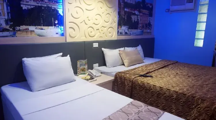 Neat hotel room with two beds at Eurotel Baguio