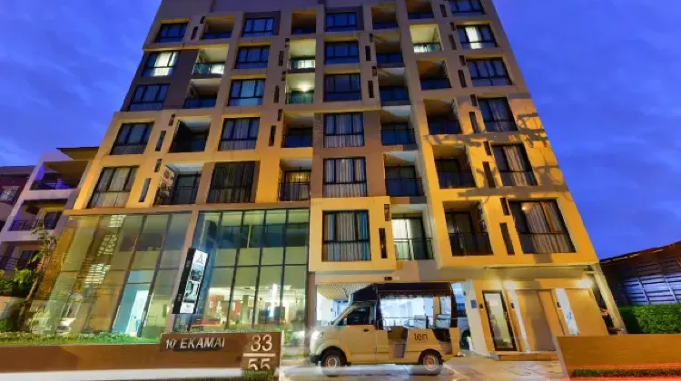 Lighted exterior of hotel building at night at Ramada by Wyndham Bangkok Ten Ekamai Residences