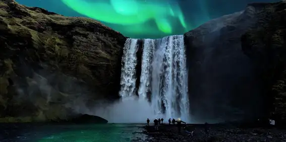 waterfall with northern lights in the sky