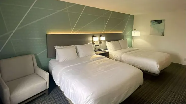 Clean hotel room with bed and sofa at Comfort Inn & Suites Louisville Airport Fair & Expo