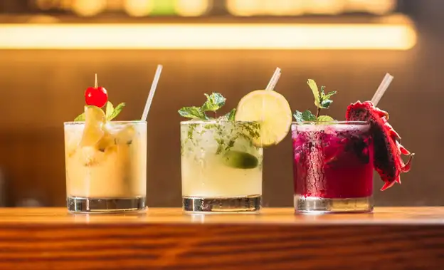 3 cocktails on a wooden countertop