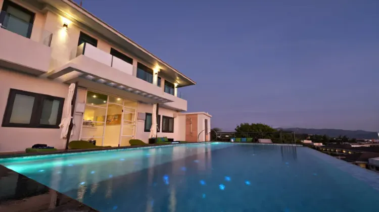Outdoor swimming pool on the top floor of the hotel at night at Lime Hotel Boracay
