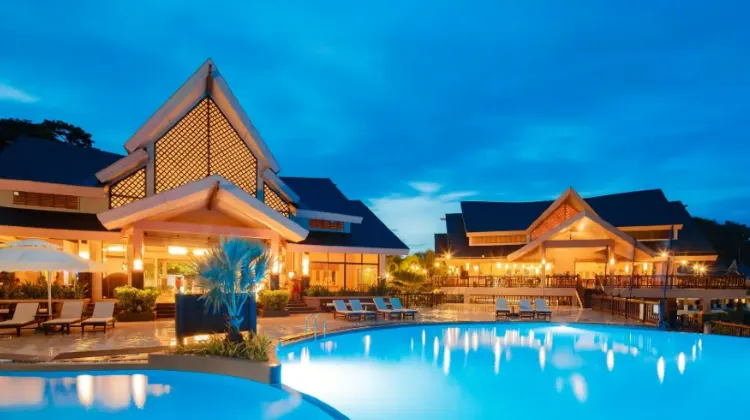 Oval-shaped spacious outdoor swimming pool and classical style hotel architecture at Alta Vista de Boracay