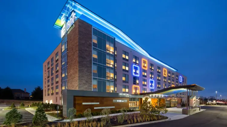 Night view of a modern hotel building at Aloft Louisville East