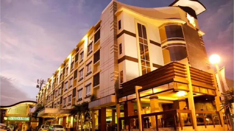Modern hotel building in warm light at MO2 Westown Hotel Iloilo