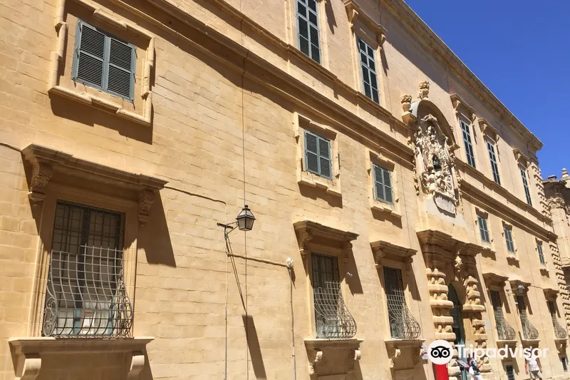 Guide leading visitors down a historic Valletta street