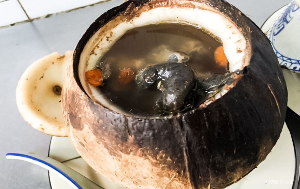 Silkie chicken soup served in a whole coconut