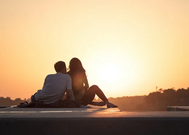 Couple cuddling during sunset