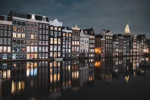 Canal houses by the water at night