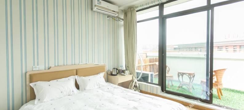 苏州圆石小歇主题宾馆(苏州科技大学石湖校区店)图片